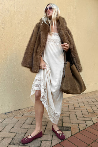 model-styling-golden-brown-recycled-polyester-faux-fur-coat-over-cream-lace-trim-dress-street-setting